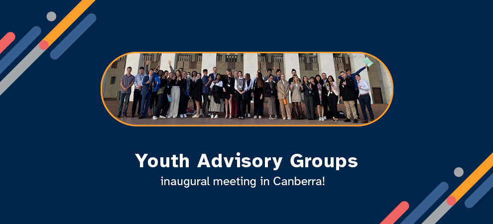 A group of young happy people from the Youth Advisory group standing out the front of the Australian Parliament House