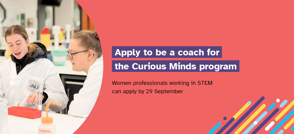 Two women wearing white lab coats working in a laboratory. Includes the words: ‘Apply to be a coach for the Curious Minds program. Women professionals working in STEM can apply by 29 September 2023.’