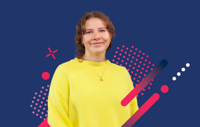 Photo of Heather smiling in front of a dark blue background